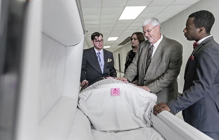 East Mississippi Community College Funeral Services Technology instructor Kevin Hurt, second from right, shows students Samuel Bertrand of Hamilton, Austyn Antley of Downsville, La., and Leonard Williams, Jr. of Columbus a casket in this photo taken from last year. East Mississippi Community College Funeral Services Technology instructor Kevin Hurt, second from right, shows students Samuel Bertrand of Hamilton, Austyn Antley of Downsville, La., and Leonard Williams, Jr. of Columbus a casket in this photo taken from last year.