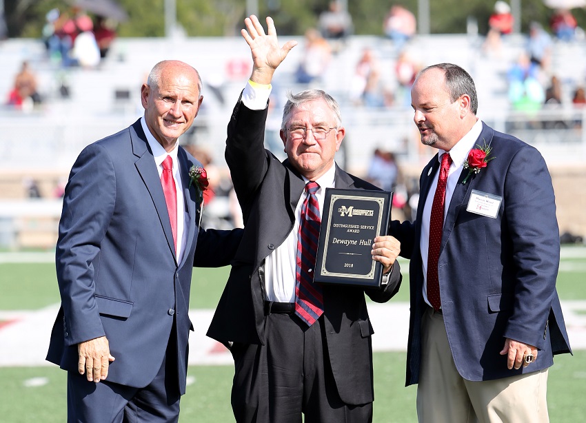 Kemper County native Dewayne Hull, at center, is presented with East Mississippi Community College’s 2018 Distinguished Service Award Oct. 13 during halftime of the college’s Homecoming game. Presenting the award are EMCC Interim President Dr. Randall Bradberry, at left, and EMCC Executive Director of College Advancement Marcus Wood, at right. Kemper County native Dewayne Hull, at center, is presented with East Mississippi Community College’s 2018 Distinguished Service Award Oct. 13 during halftime of the college’s Homecoming game. Presenting the award are EMCC Interim President Dr. Randall Bradberry, at left, and EMCC Executive Director of College Advancement Marcus Wood, at right.